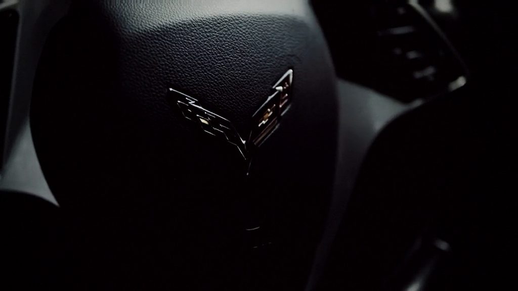 Corvette crossed-flags emblem on the steering wheel at night