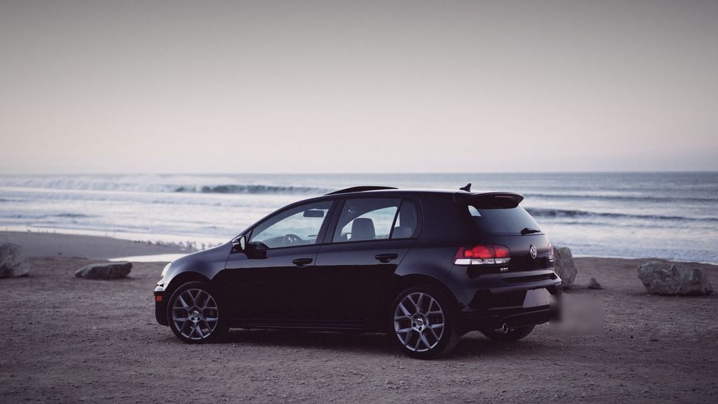 Black Volkswagen Golf GTI on a beach at dusk — performance tuning Milton by Wolf Performance