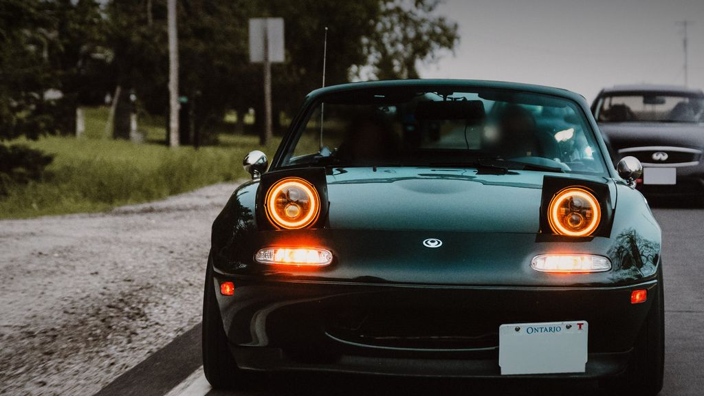 Green Mazda Miata with halo headlights on a country road — ECU remap Newmarket & Aurora by Wolf Performance