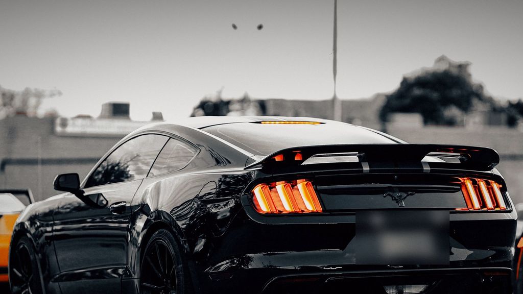 Black Ford Mustang with its tail lights glowing — ECU remap Etobicoke by Wolf Performance