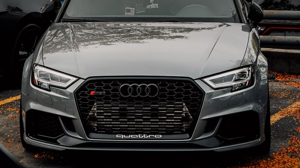 Grey Audi RS3 hatchback, front three-quarter view