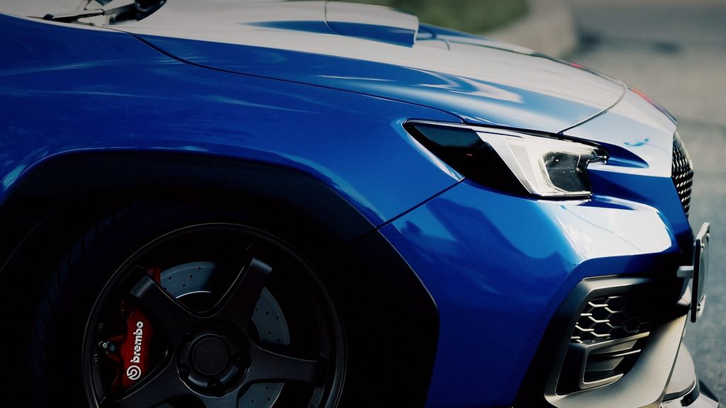 Blue Subaru WRX STI wheel with red Brembo brakes