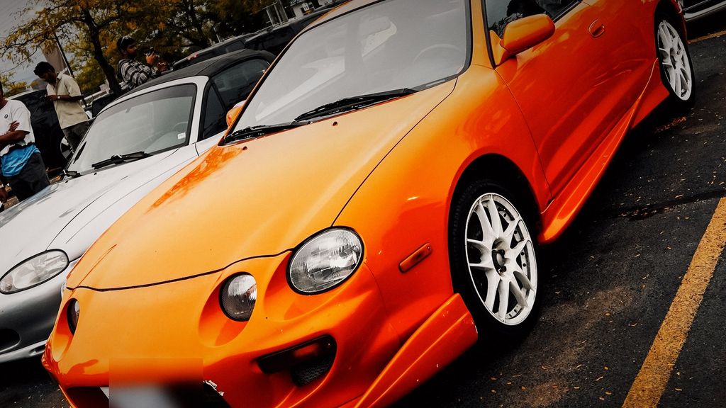 Orange Toyota sports coupe with white wheels — performance tuning Cambridge by Wolf Performance